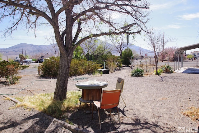 view of yard featuring a mountain view and fence