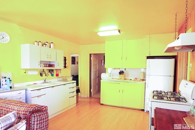 kitchen featuring under cabinet range hood, light countertops, a sink, white appliances, and light wood-type flooring