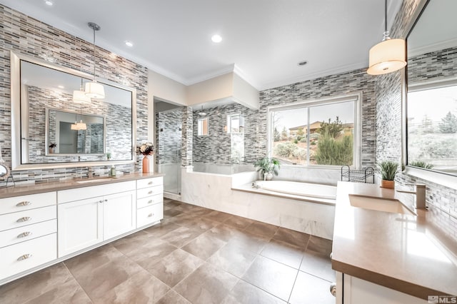 full bath featuring walk in shower, ornamental molding, a garden tub, vanity, and tile patterned flooring
