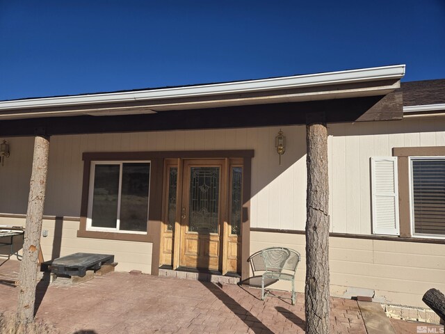 property entrance featuring a patio area