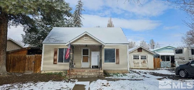 bungalow-style house with fence