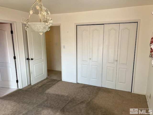 unfurnished bedroom featuring a closet and carpet