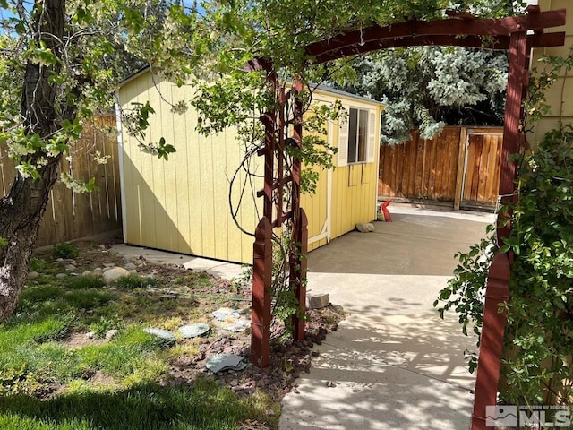 exterior space featuring an outdoor structure, a storage shed, and a fenced backyard