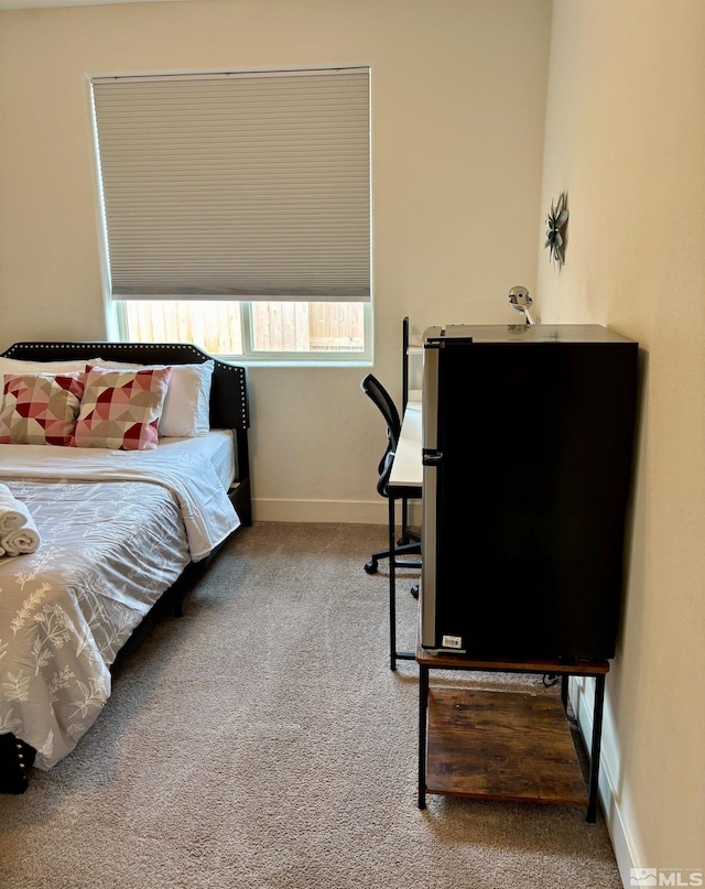 carpeted bedroom with baseboards