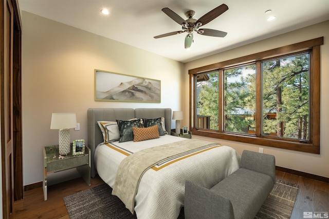 bedroom with dark wood-style floors, recessed lighting, and baseboards