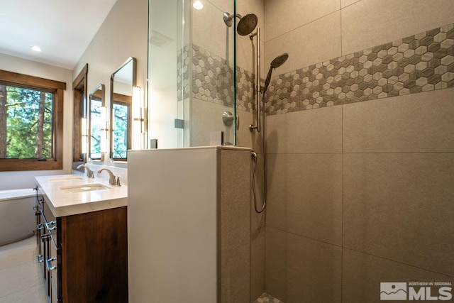 full bathroom featuring toilet, a tile shower, and vanity