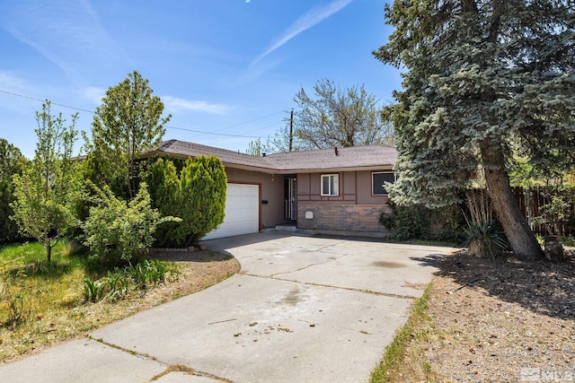 ranch-style house featuring driveway, brick siding, a shingled roof, and an attached garage