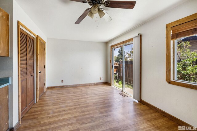 unfurnished bedroom with baseboards, visible vents, access to exterior, and light wood-style floors