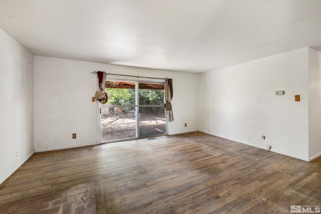 unfurnished room featuring wood finished floors and baseboards