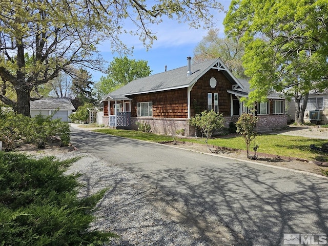view of front facade with an outdoor structure, a front lawn, and a garage