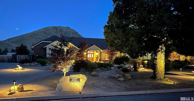 view of front of property featuring a mountain view and fence
