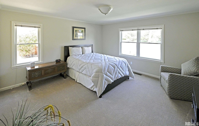 carpeted bedroom with baseboards, ornamental molding, and visible vents