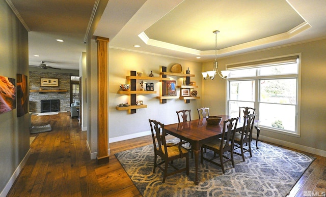 dining area featuring baseboards, ornamental molding, ceiling fan with notable chandelier, and dark wood-style floors
