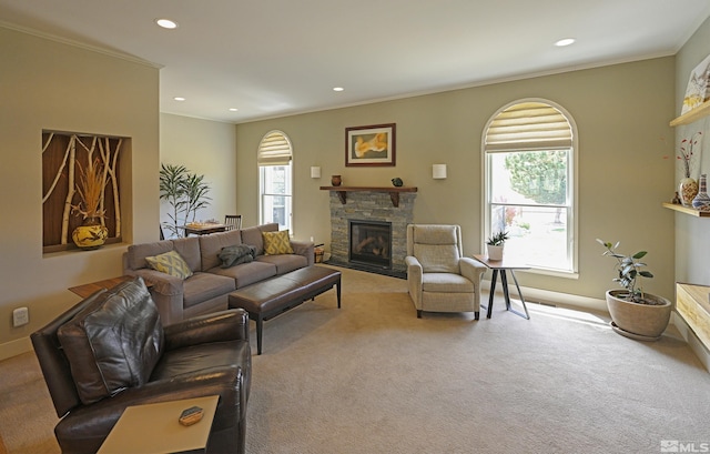 carpeted living area with recessed lighting, baseboards, a stone fireplace, and ornamental molding