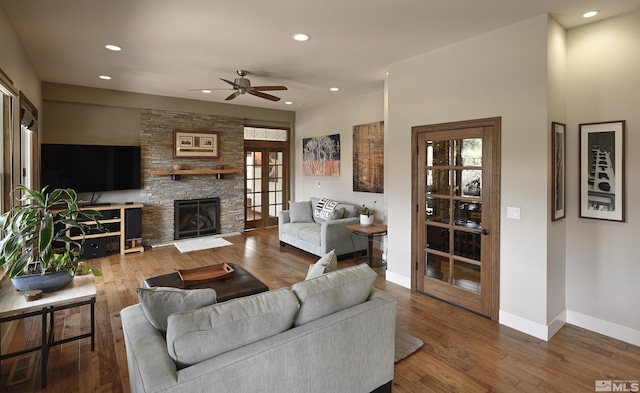 living area with hardwood / wood-style flooring, baseboards, a ceiling fan, and recessed lighting