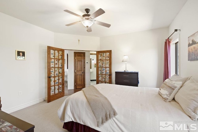 carpeted bedroom with ceiling fan and baseboards