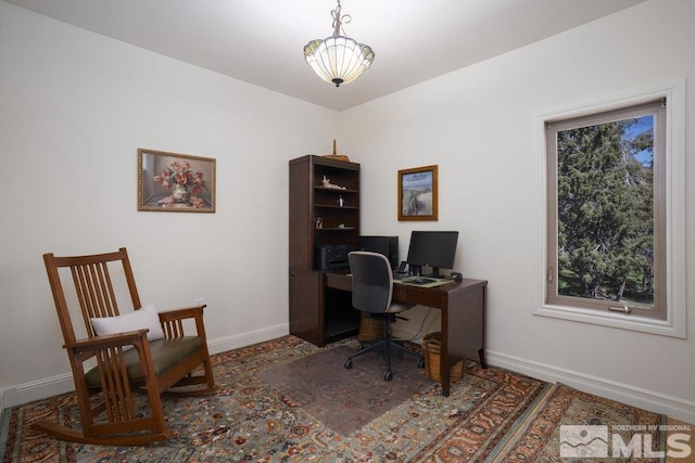 home office with a wealth of natural light and baseboards