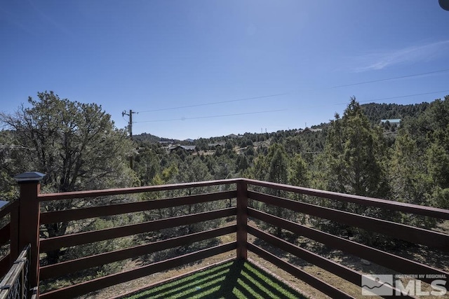 balcony featuring a view of trees