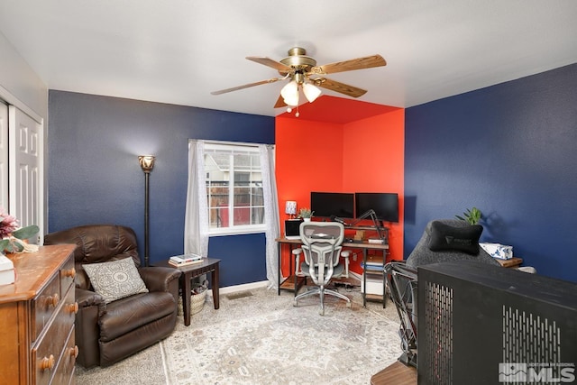 office area with ceiling fan and baseboards