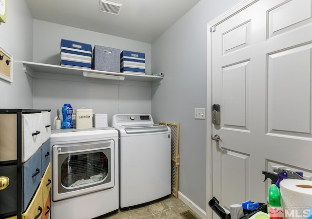 laundry room featuring washer and dryer, visible vents, laundry area, and baseboards