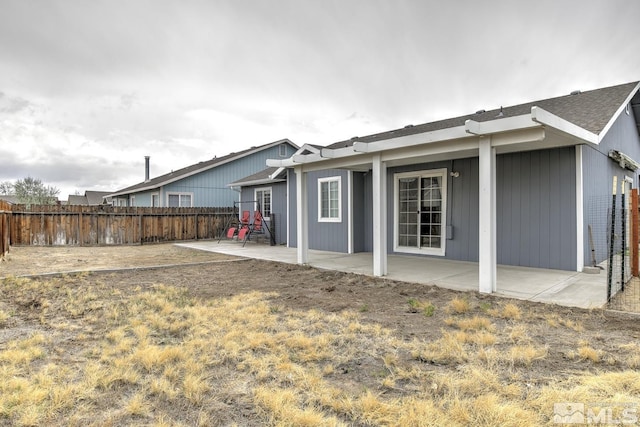 rear view of property with a patio and a fenced backyard