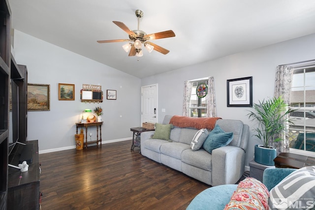 living area featuring baseboards, wood finished floors, a ceiling fan, and vaulted ceiling