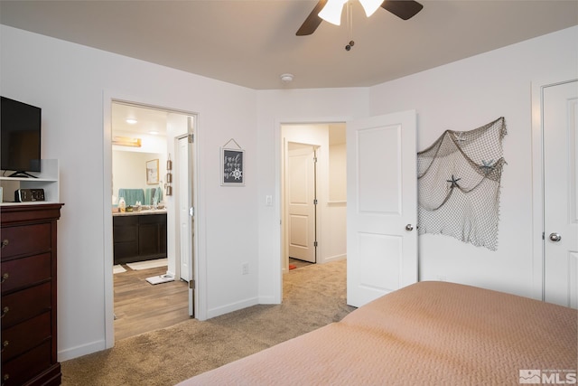 unfurnished bedroom featuring ensuite bathroom, a ceiling fan, carpet, and baseboards