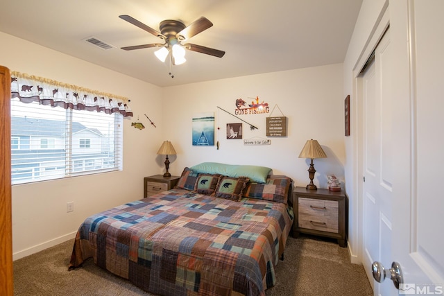 carpeted bedroom with visible vents, ceiling fan, baseboards, and a closet