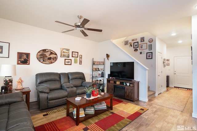 living room with recessed lighting, stairs, light wood-style floors, baseboards, and a ceiling fan