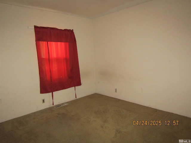 carpeted spare room with visible vents