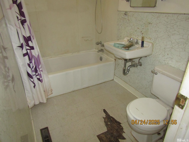 full bathroom featuring toilet, a sink, visible vents, and shower / tub combo