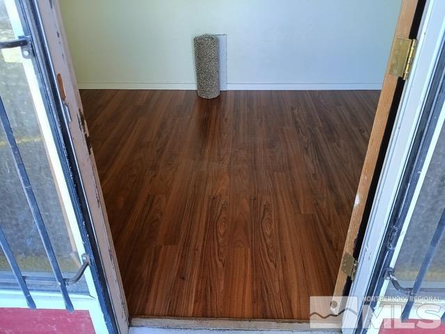 interior space featuring wood finished floors and baseboards