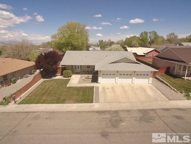 view of front facade featuring a front lawn, concrete driveway, and an attached garage