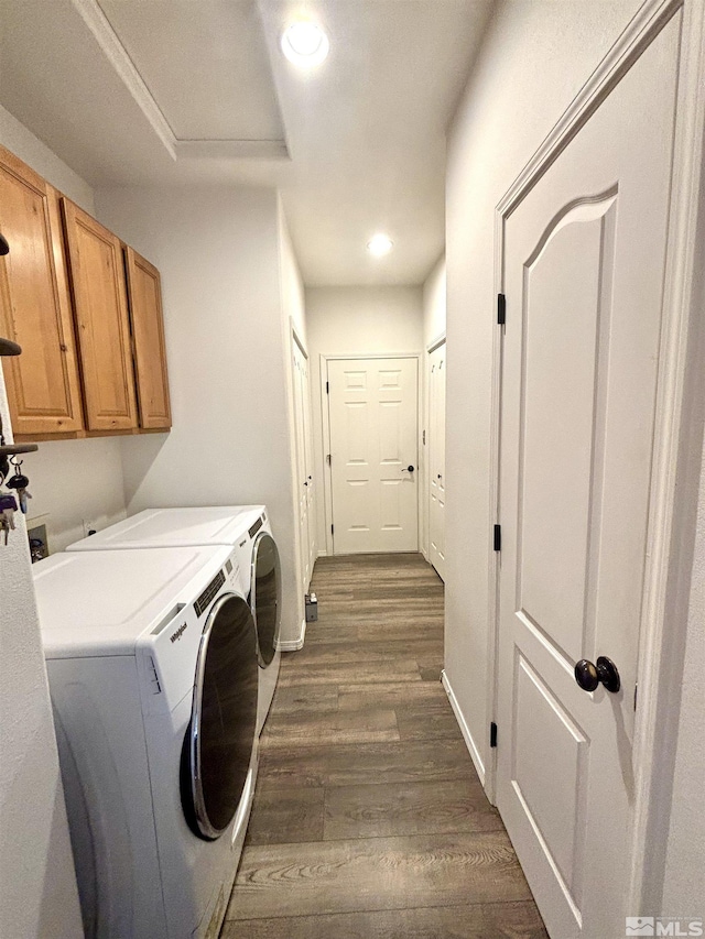 laundry area with recessed lighting, washer and dryer, cabinet space, and dark wood finished floors