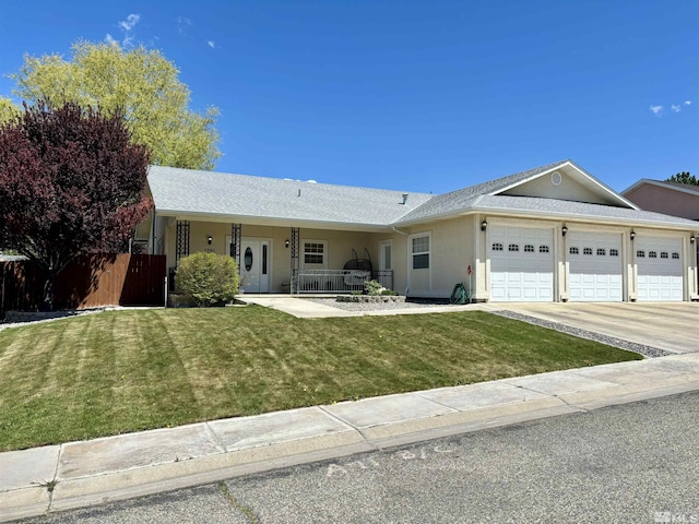 single story home with stucco siding, fence, a garage, a front lawn, and concrete driveway