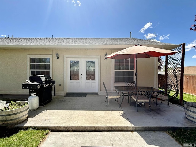 exterior space featuring a grill, fence, and outdoor dining space