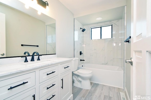 full bathroom with vanity, shower / tub combination, wood finished floors, and toilet