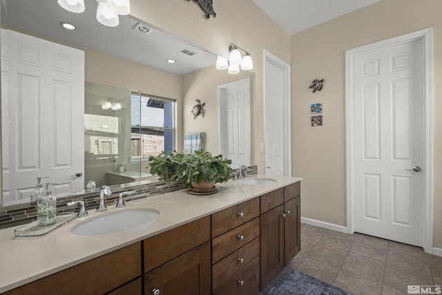 full bath with a sink, double vanity, a chandelier, and visible vents
