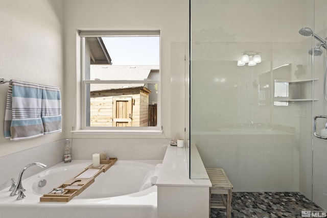 full bath featuring a bath and a shower stall