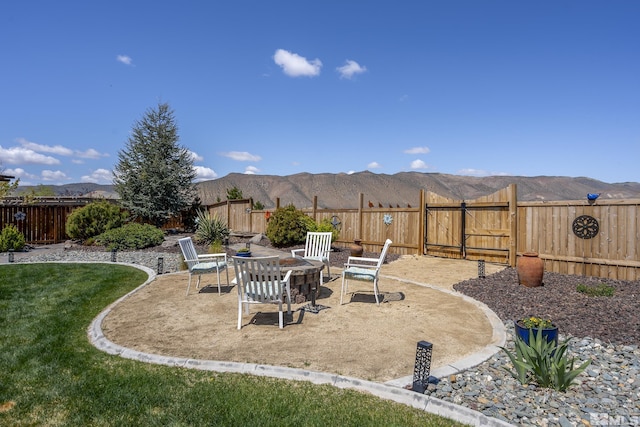 view of yard with a fenced backyard, a patio area, and a mountain view