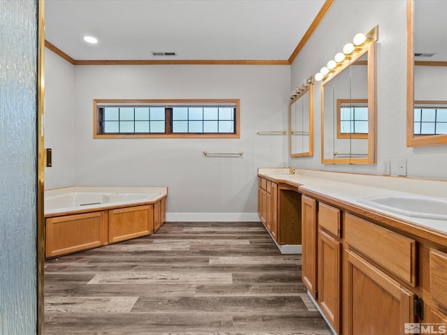 bathroom featuring crown molding, double vanity, wood finished floors, visible vents, and a garden tub