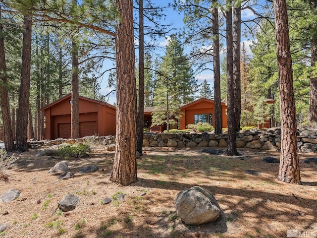 view of front of property featuring a garage and an outbuilding