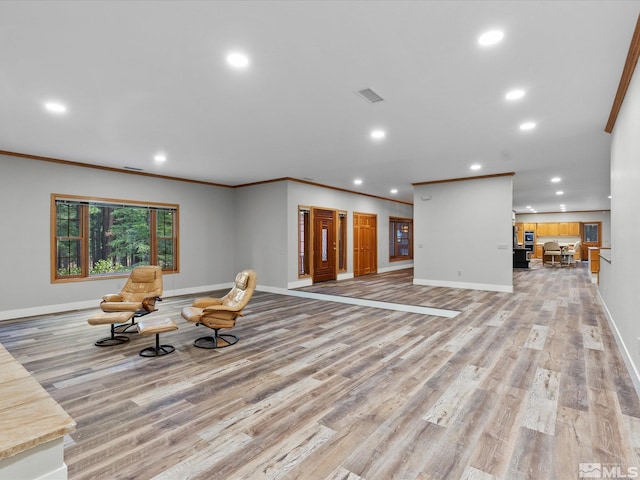 unfurnished living room featuring baseboards, recessed lighting, and light wood-style floors