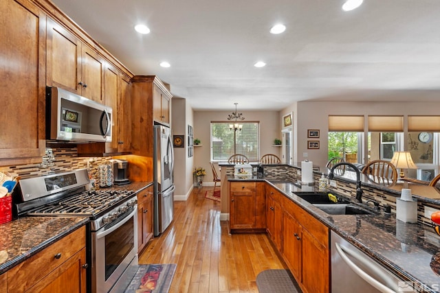 kitchen with recessed lighting, a sink, plenty of natural light, and appliances with stainless steel finishes