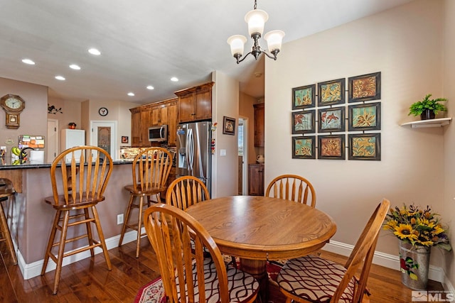 dining area with baseboards, recessed lighting, dark wood finished floors, and a chandelier