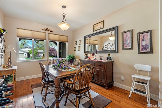 dining area featuring baseboards and light wood-style floors