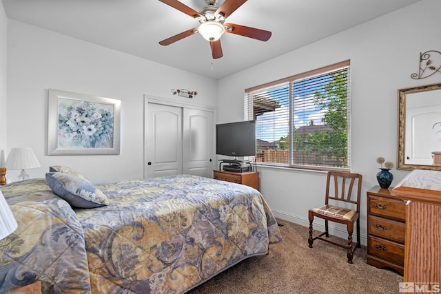 carpeted bedroom featuring a closet, a ceiling fan, and baseboards