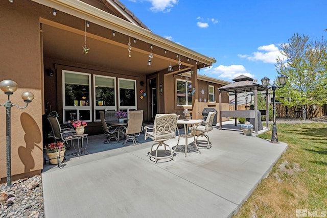 view of patio / terrace featuring fence and a gazebo