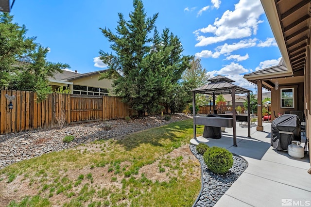 view of yard with a gazebo, a fenced backyard, and a patio area