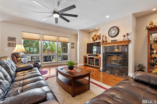 living room featuring a ceiling fan, recessed lighting, wood finished floors, and a fireplace